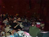 Attendees settling in with their pillows and sleeping bags.